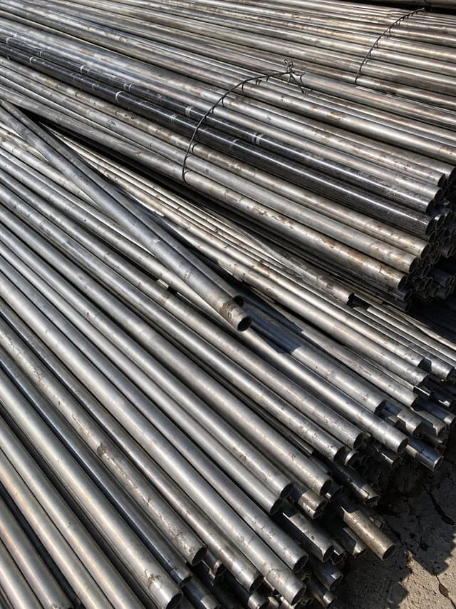 Bundled stainless steel pipe offcuts stacked for export.