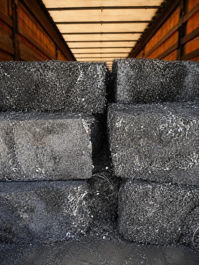 Baled aluminium turnings stacked inside a trailer.