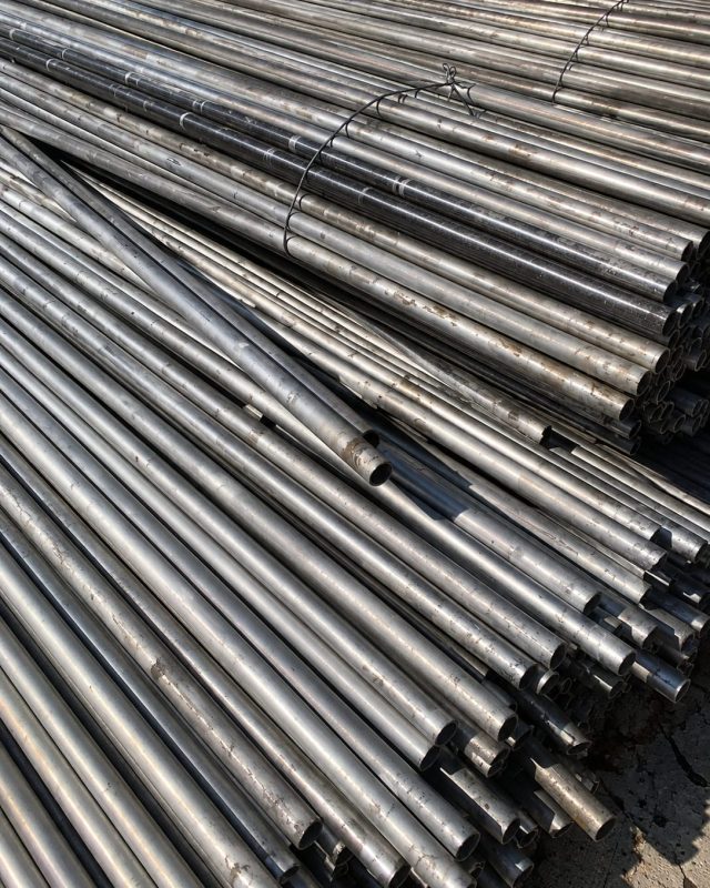 Bundled stainless steel pipe offcuts stacked for export.